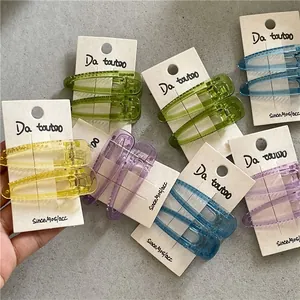 Detailed macro of translucent colorful plastic drop hair clips with non-slip duckbill design