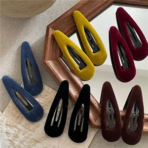 Set of retro velvet teardrop snap hair clips in navy blue, yellow, and burgundy colors