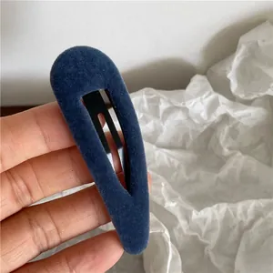 Detail shot of navy blue velvet teardrop BB hair clip with textured fabric finish