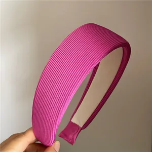 Detail showing the thick ribbed texture and non-slip lining of the wide rose red headband