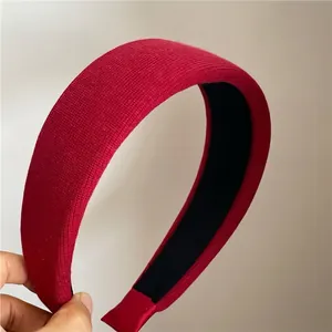 Detailed macro view of the red ribbed knit fabric and thick padded sponge texture on headband