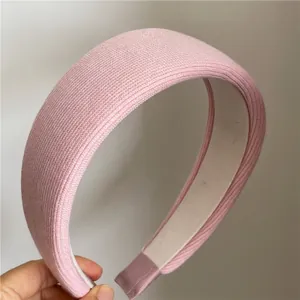 Detailed close-up of pink padded knit headband showing soft fabric texture and ends