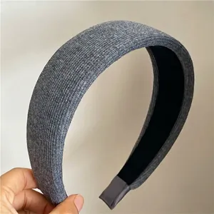 Macro shot of wide gray knitted headband featuring vertical striped texture and soft fabric