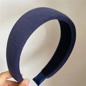 Detail of navy blue knitted headband showing thick padded texture and non-slip inner lining