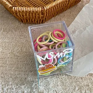 Detail of colorful seamless elastic hair ties set in a cute branded transparent box