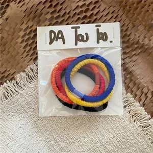 Detail view of colorful woven elastic hair ties with textured ribbed patterns in pack
