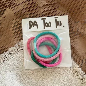Detail view of colorful high-elasticity hair ties with ribbed texture in a gift package