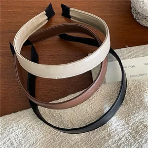Classic stitched faux leather headbands in beige, brown and black for a minimalist look