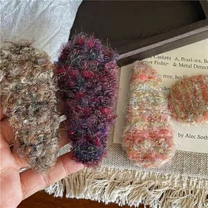 Chic set of colorful bouclé knit teardrop hair clips with warm artistic styling