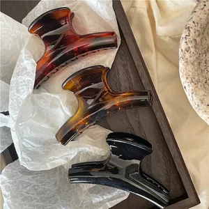 Three-piece large resin hair claws set in amber and black with high gloss finish