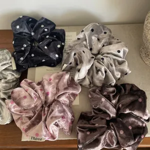 Chic velvet polka dot scrunchie set in black, grey, and pink for elegant hair styling