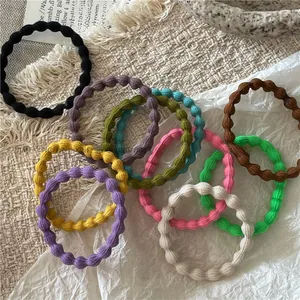Detailed close-up of textured pastel elastic hair ties in a stylish flat lay arrangement