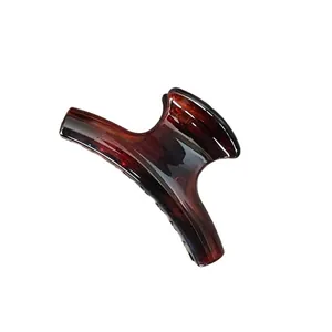 Polished amber tortoiseshell hair claw clip for women in a vintage minimalist style