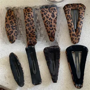 Front and back view of leopard print plush hair clips in geometric shapes for women
