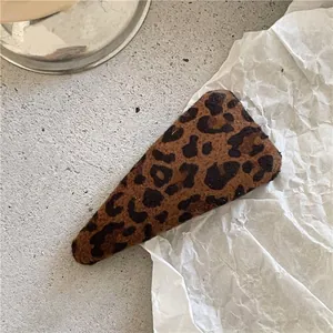 Close-up of a triangular leopard print flocked BB hair clip with a soft velvet texture