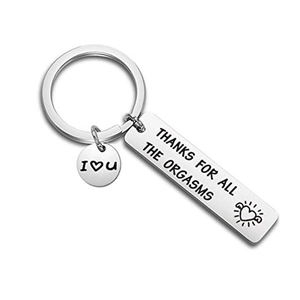 Detailed macro of stainless steel keychain with playful romantic engraving for couples
