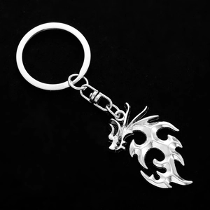 Polished silver dragon keychain with intricate hollow design for backpacks and cars