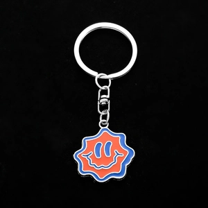 Funny metal keychain with wavy star pendant and orange blue enamel smiley face design