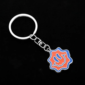 Funny wave-shaped metal keychain with blue and orange graffiti face charm on black background