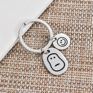 Creative stainless steel keychain featuring minimalist round and oval smiley face charms