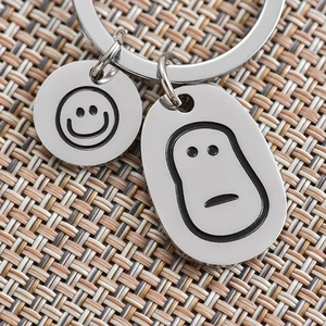 Polished stainless steel keychain with smiling face and cartoon character pendants