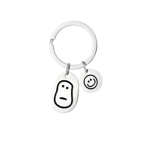 Creative stainless steel keychain featuring oval and round smiley face charms on a silver ring