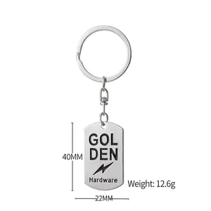 Silver metal rectangular tag keychain with engraved lightning bolt and golden hardware logo