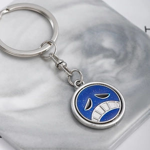 Rotating metal keychain featuring One Piece anime symbol with blue enamel finish