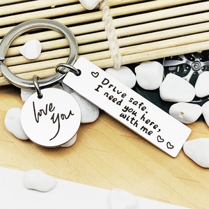 Stainless steel keychain with Drive Safe I need you here engraving and a small love charm