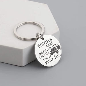 Silver Bundys Taxi Service keychain with engraved beetle car on a geometric base