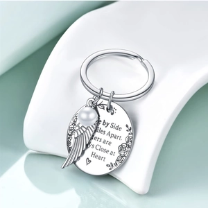 Silver stainless steel sister keychain with pearl, wing pendant and engraved quote plaque