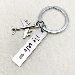 Polished stainless steel fly safe airplane keychain with engraved pendant on white leather