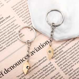 Detailed view of magnetic gold heart couple keychains with sun and moon engraved charms