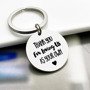 Macro detail of engraved stainless steel keychain with Thank You For Loving Us text