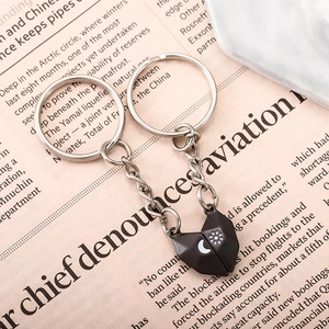 Magnetic sun and moon heart couple keychains in black finish on vintage background