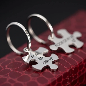 Matching puzzle piece couple keychains with Sun and Stars engraving in a gift box