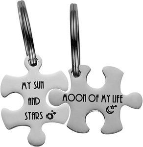 Detail of puzzle couple keychains engraved with My Sun and Stars and Moon of My Life