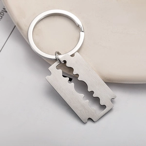 Minimalist stainless steel razor blade keychain with silver brushed metal finish for bags