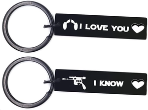 Detail of black couple keychains with Star Wars quotes and hollow heart cutout designs