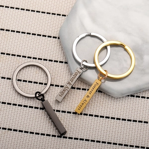 Detail of engraved Forever & Always text on cubic stainless steel bar keychains