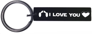Detail of black rectangular keychain with white I LOVE YOU text and hollow heart design
