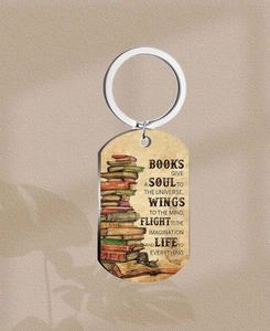Close-up of stainless steel keychain with vintage book illustration and inspirational quote