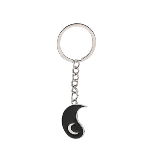 Detailed view of black metal tai chi moon pendant with polished silver chain