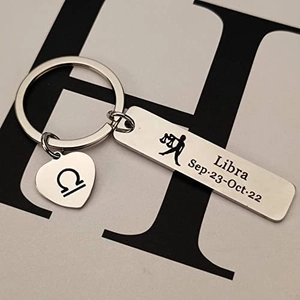 Polished stainless steel Libra zodiac keychain with a heart charm and date engraving