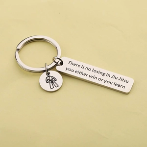 Polished stainless steel Jiu Jitsu keychain with motivational quote and martial arts charm