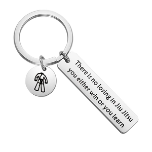 Stainless steel Jiu Jitsu keychain with martial arts uniform charm and inspiring quote