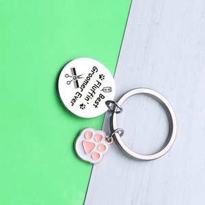 Silver dog groomer keychain with paw charm and Best Fluffin' Groomer Ever engraving