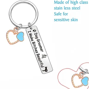 Dog groomer keychain with blue heart charm and engraved humorous slogan in stainless steel