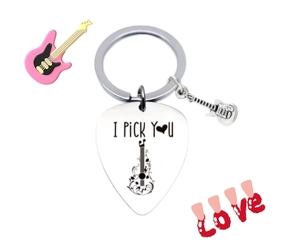 Detail of stainless steel guitar pick keychain with I Pick You engraving and mini charm