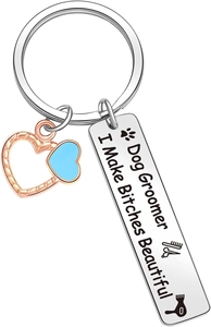 Close-up of dog groomer keychain with blue heart and engraved stainless steel charm